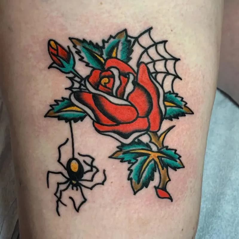 a rose tattoo with a spider