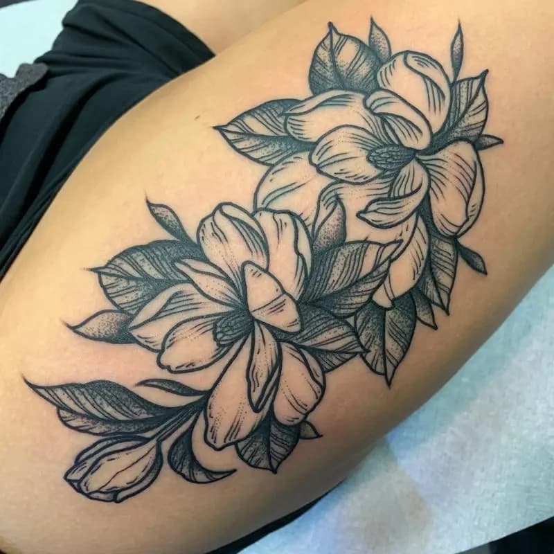 a tattoo of a black and white flower