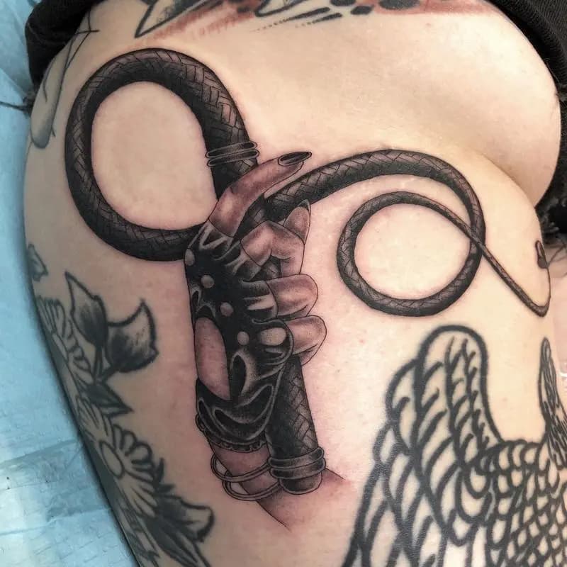 a tattoo of a  hand with a whip