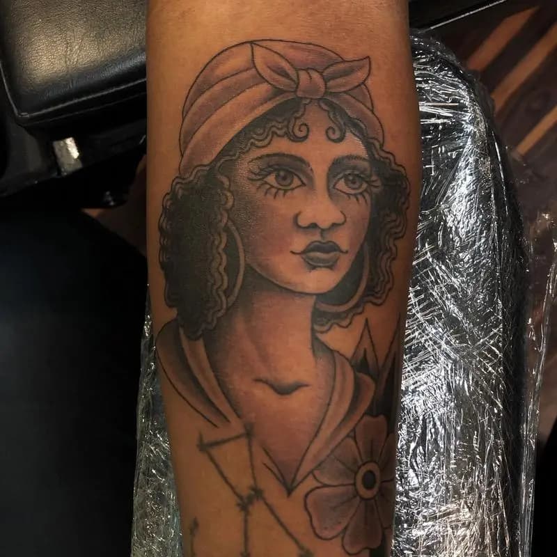 a tattoo of a woman in a person's arm