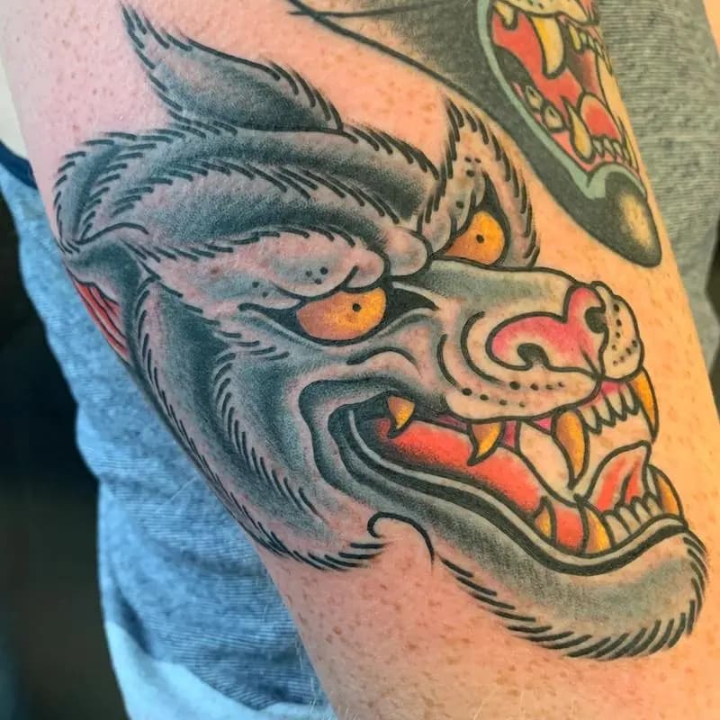 a tattoo of a wolf on a person's arm